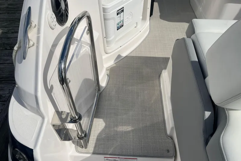 Slide: The Image of 2023 Regal 28 Express boat interior with seating and stainless steel railing. - 9