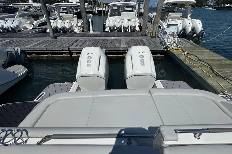 Slide: The Image of 2023 Sea Ray SLX 400 Outboard with twin 600 V12 engines docked at marina. - 12