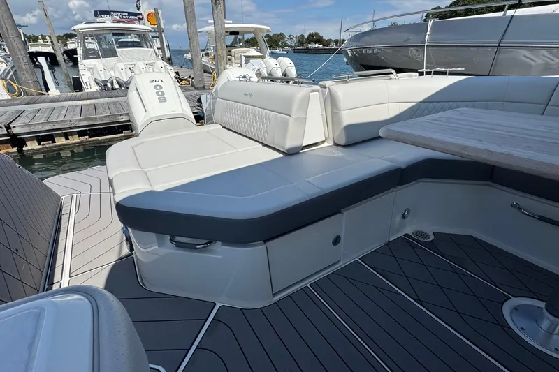 Slide: The Image of 2023 Sea Ray SLX 400 Outboard boat interior with luxurious seating and table. - 13