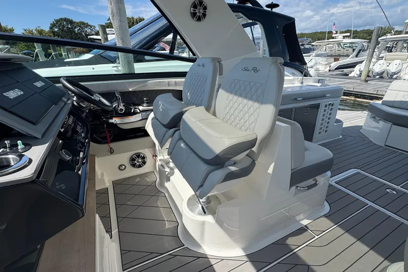 Slide: The Image of 2023 Sea Ray SLX 400 Outboard helm with luxurious seating and modern controls. - 24