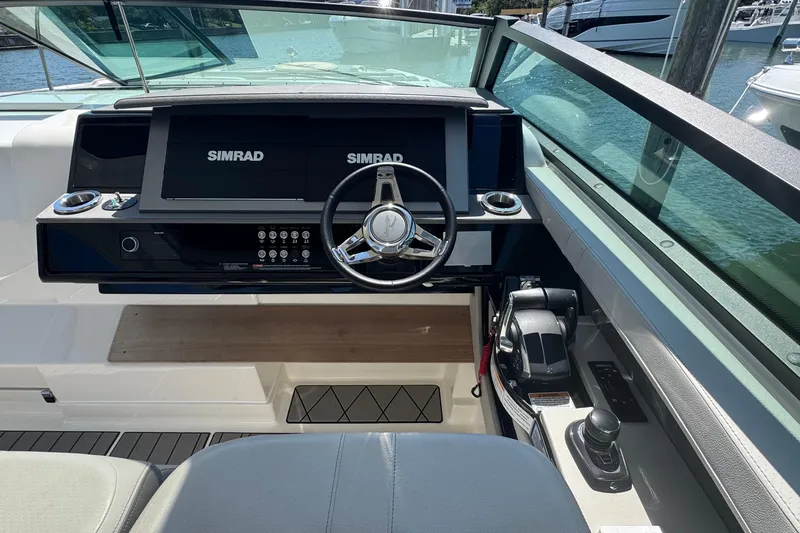 Slide: The Image of 2023 Sea Ray SLX 400 Outboard helm with Simrad displays and modern controls. - 25