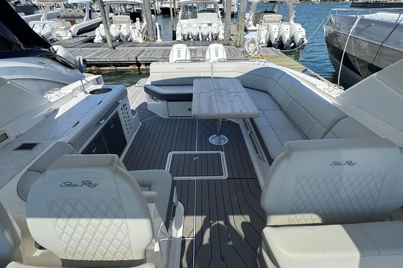 Slide: The Image of Luxurious 2023 Sea Ray SLX 400 Outboard boat interior with elegant seating and table. - 28