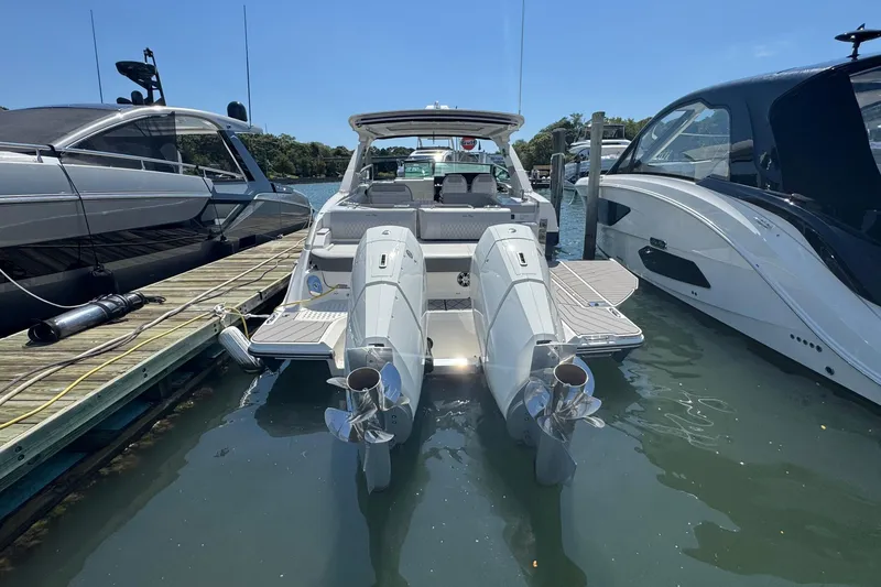 Slide: The Image of 2023 Sea Ray SLX 400 Outboard docked, showcasing dual outboard engines and sleek design. - 3