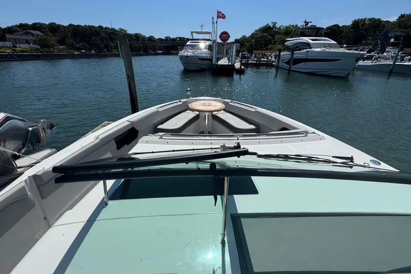 Slide: The Image of 2023 Sea Ray SLX 400 Outboard boat docked in a scenic marina. - 34