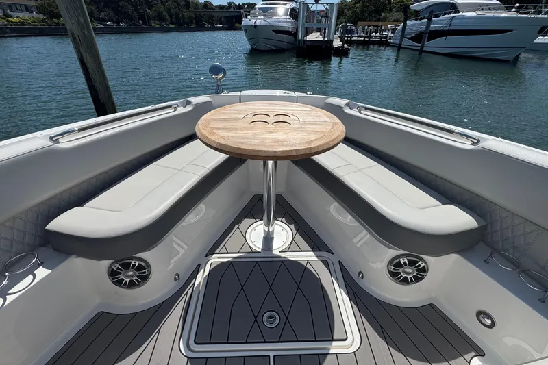 Slide: The Image of 2023 Sea Ray SLX 400 Outboard boat interior with seating and wooden table. - 36