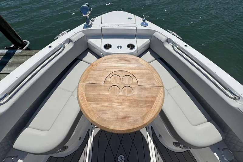 Slide: The Image of 2023 Sea Ray SLX 400 Outboard boat with wooden table and cushioned seating. - 37