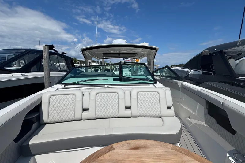 Slide: The Image of 2023 Sea Ray SLX 400 Outboard luxury boat interior with plush seating and sleek design. - 38