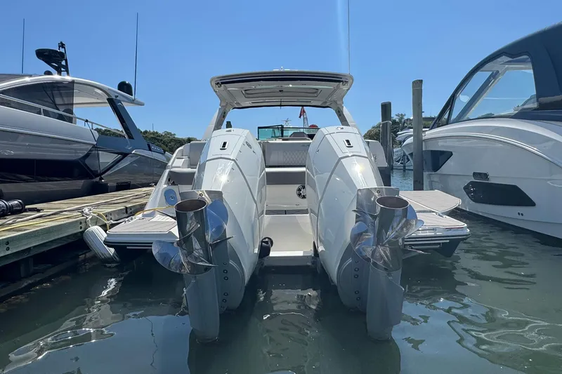 Slide: The Image of 2023 Sea Ray SLX 400 Outboard docked, showcasing dual engines and sleek design. - 4