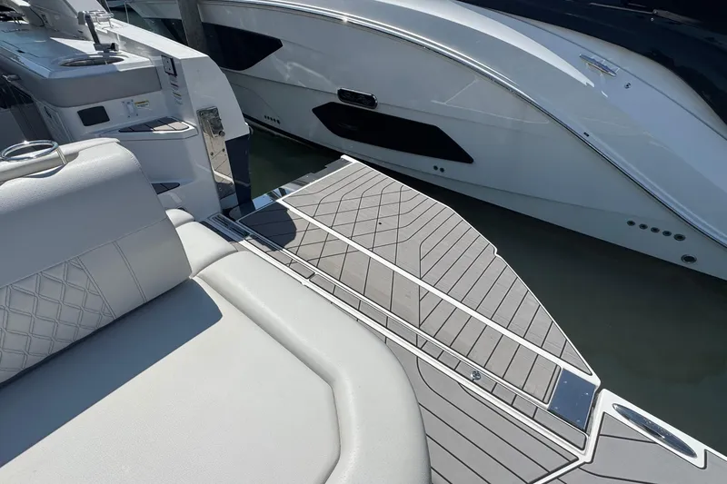 Slide: The Image of 2023 Sea Ray SLX 400 Outboard boat with luxurious seating and sleek deck design. - 9