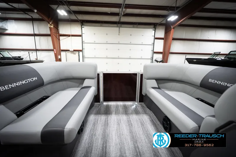 Slide: The Image of 2026 Bennington 168 SLJ pontoon boat interior with gray seating in a showroom. - 19