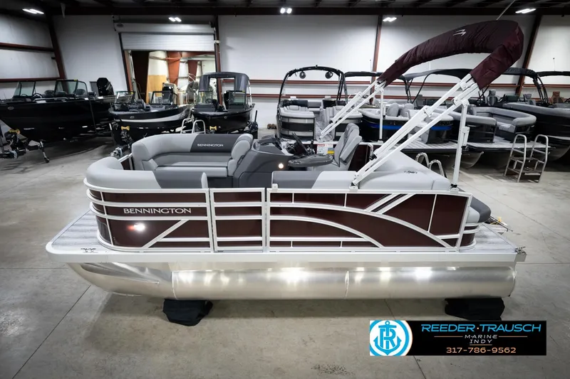 The Image of 2026 Bennington 168 SLJ pontoon boat in showroom, featuring sleek design and comfortable seating. - 2