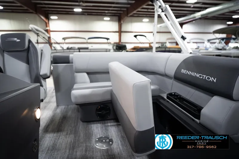Slide: The Image of 2026 Bennington 168 SLJ boat interior with gray seating in a showroom. - 23