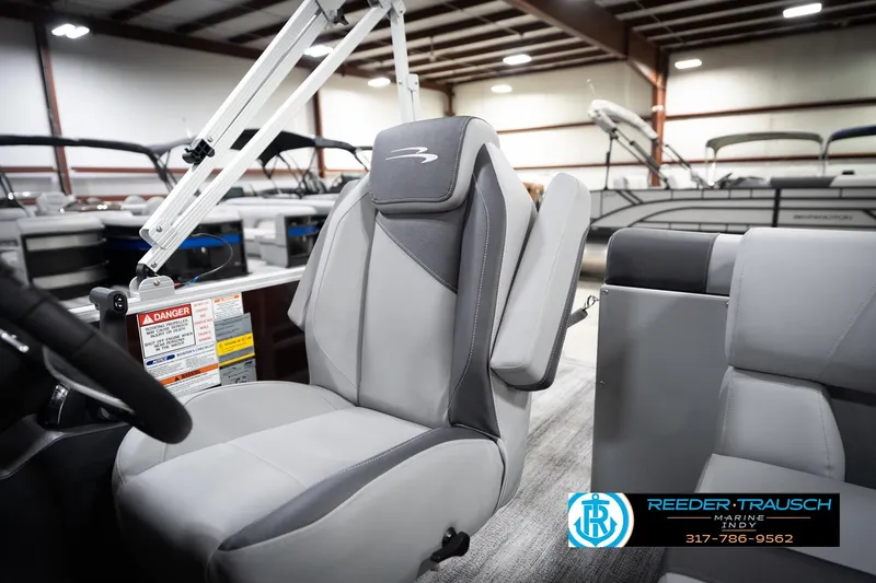 Slide: The Image of 2026 Bennington 168 SLJ boat interior with gray seating in a showroom. - 25
