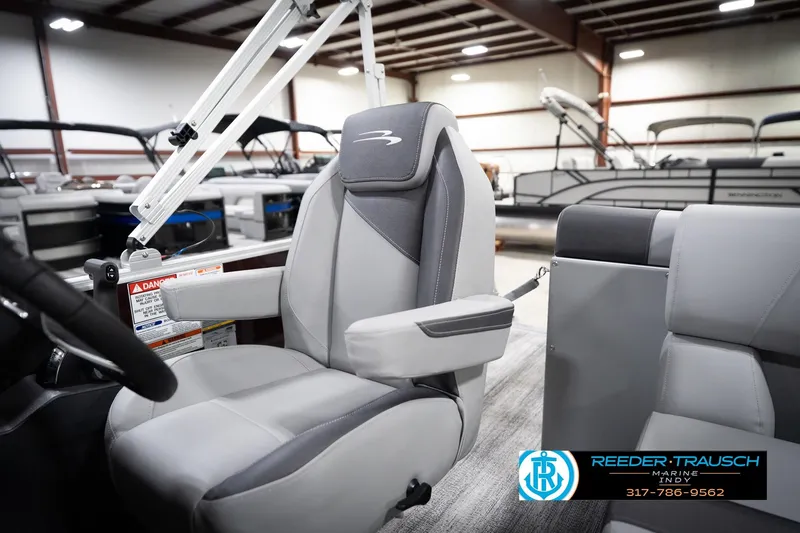 Slide: The Image of 2026 Bennington 168 SLJ boat interior with gray seating in a showroom. - 26