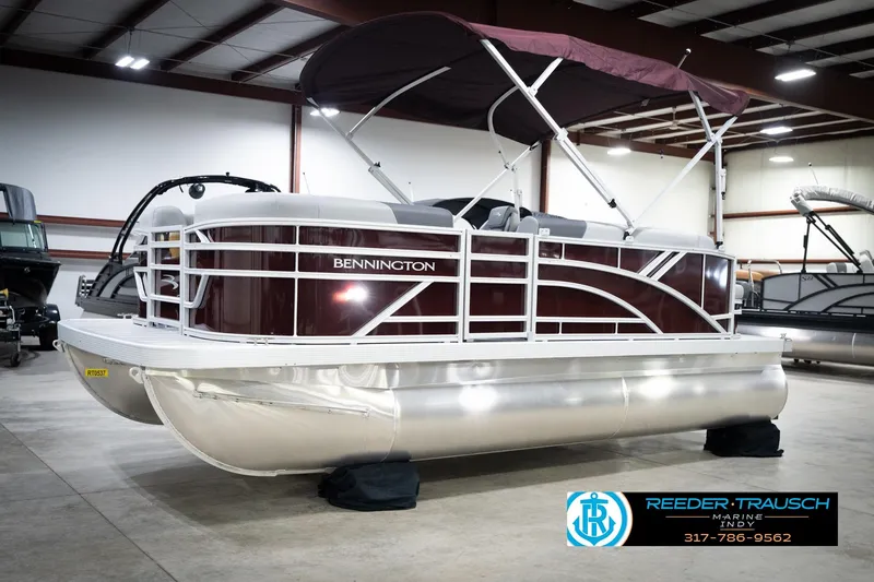 Slide: The Image of 2026 Bennington 168 SLJ pontoon boat in showroom with maroon and silver design. - 4