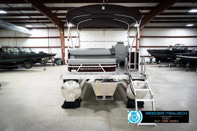 Slide: The Image of 2026 Bennington 168 SLJ pontoon boat in showroom, featuring sleek design and modern amenities. - 9