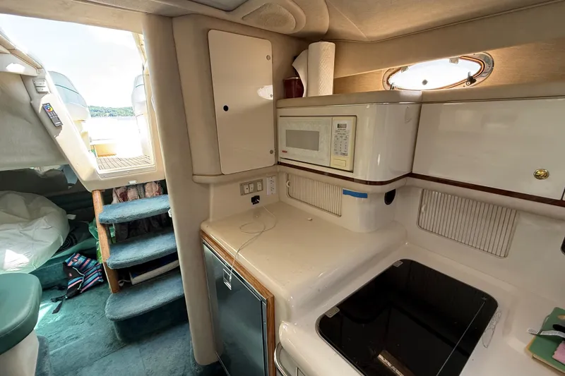 Slide: The Image of Interior of 1995 Sea Ray 330 Sundancer with kitchenette and stairs to deck. - 11