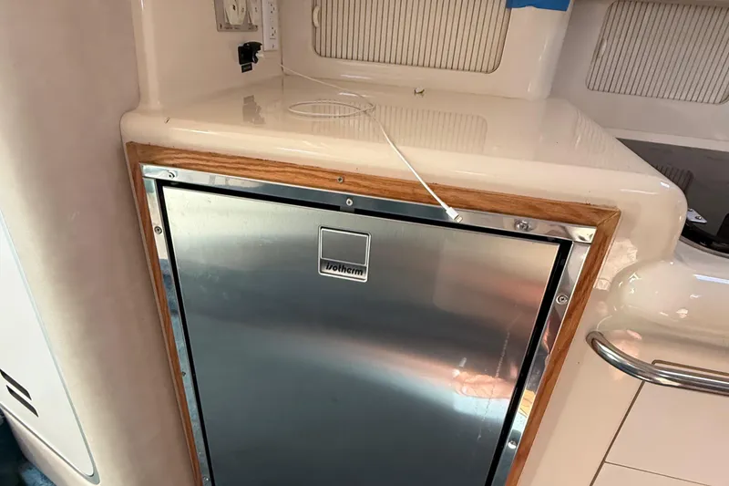 Slide: The Image of 1995 Sea Ray 330 Sundancer interior with built-in stainless steel fridge. - 15