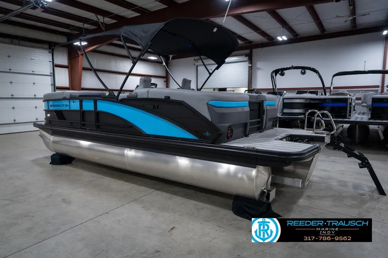 Slide: The Image of 2026 Bennington 22 MFB pontoon boat in showroom, featuring sleek design and modern amenities. - 10