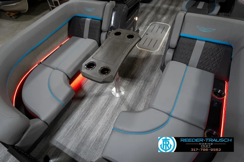 Slide: The Image of 2026 Bennington 22 MFB pontoon boat in showroom, featuring sleek design and blue accents. - 12