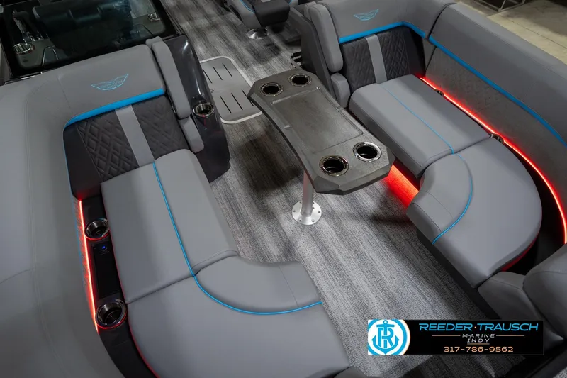Slide: The Image of 2026 Bennington 22 MFB boat interior with gray seating, blue accents, and cup holders. - 13