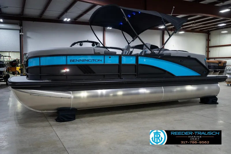 Slide: The Image of 2026 Bennington 22 MFB pontoon boat in showroom, featuring sleek design and modern amenities. - 4