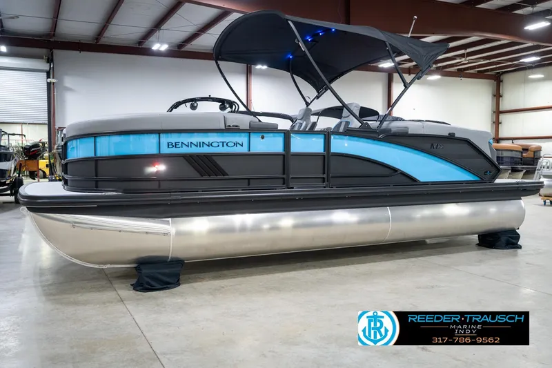 Slide: The Image of 2026 Bennington 22 MFB pontoon boat in showroom with blue and black design. - 57