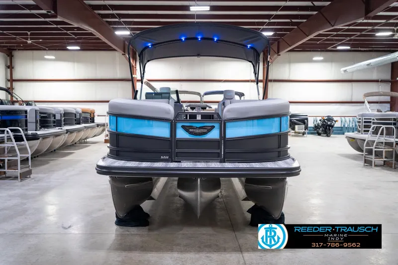 Slide: The Image of 2026 Bennington 22 MFB pontoon boat in showroom, featuring sleek design and modern amenities. - 58