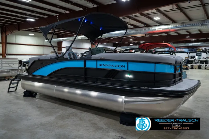 Slide: The Image of 2026 Bennington 22 MFB pontoon boat in showroom, featuring sleek design and modern amenities. - 6