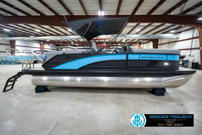 Slide: The Image of 2026 Bennington 22 MFB pontoon boat in showroom, featuring sleek design and modern amenities. - 60