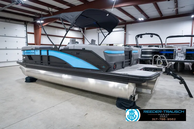 Slide: The Image of 2026 Bennington 22 MFB pontoon boat in showroom, featuring sleek design and modern amenities. - 63