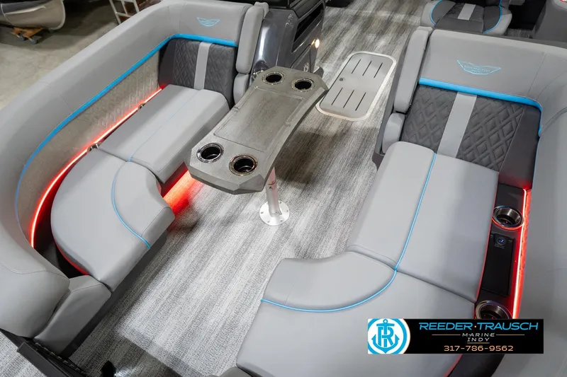 Slide: The Image of 2026 Bennington 22 MFB boat interior with gray seating, blue accents, and cup holders. - 65