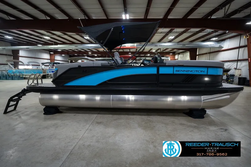 Slide: The Image of Bennington 22 MFB 2026 boat on water, promoting trade-in program with Reeder-Trausch Marine. - 7