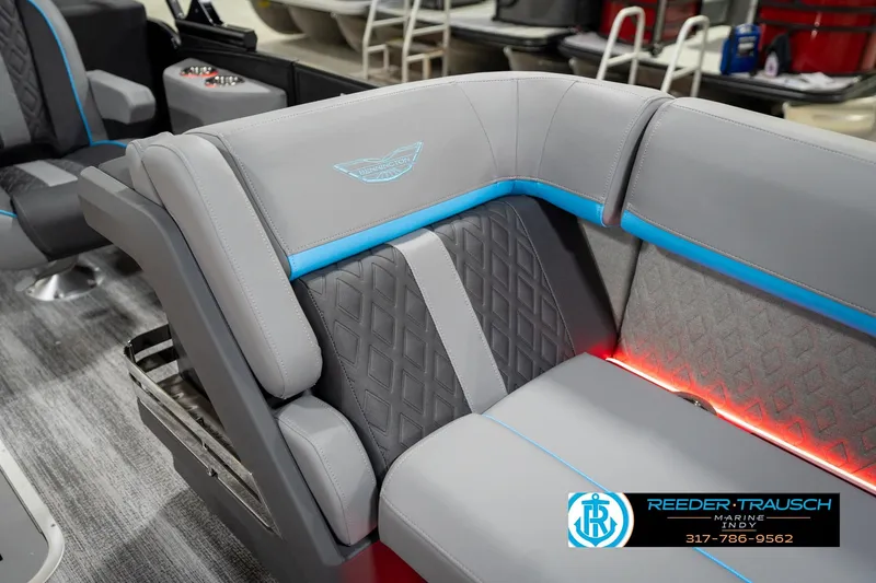 Slide: The Image of 2026 Bennington 22 MFB boat interior with gray and blue seating, featuring diamond stitching. - 77