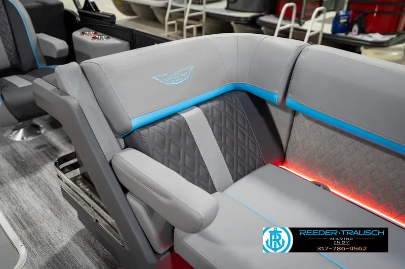 Slide: The Image of 2026 Bennington 22 MFB boat interior with gray and blue seating, red accent lighting. - 78