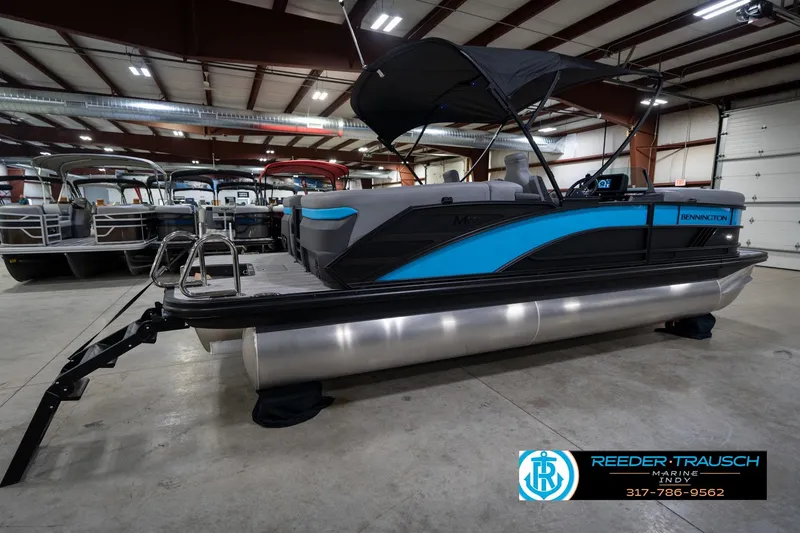Slide: The Image of 2026 Bennington 22 MFB pontoon boat in showroom with canopy and sleek design. - 8