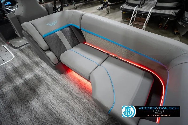 Slide: The Image of 2026 Bennington 22 MFB boat interior with gray seating, blue accents, and red LED lighting. - 95