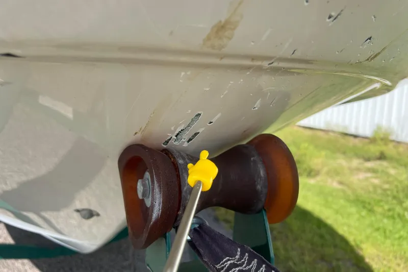 Slide: The Image of Close-up of 2007 Azure AZ240 boat hull with visible scratches and roller. - 13