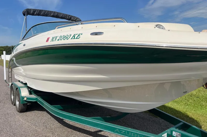 Slide: The Image of 2007 Azure AZ240 boat on trailer, green and white design, sunny day. - 15