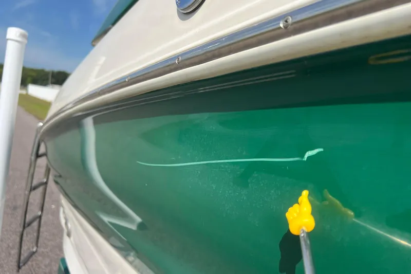 Slide: The Image of 2007 Azure AZ240 boat with scratch repair in progress on green hull. - 16