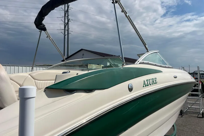 Slide: The Image of 2007 Azure AZ240 boat with green and white design, docked under cloudy sky. - 17