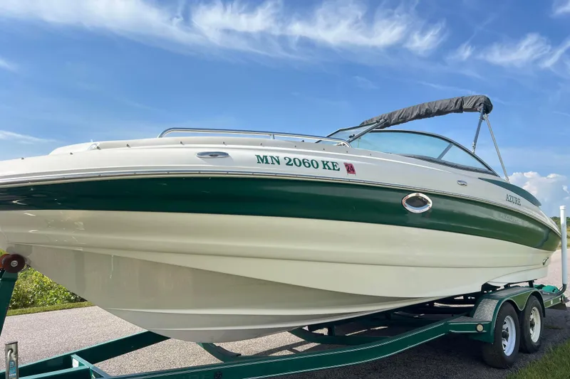 Slide: The Image of 2007 Azure AZ240 boat on trailer under clear blue sky. - 2