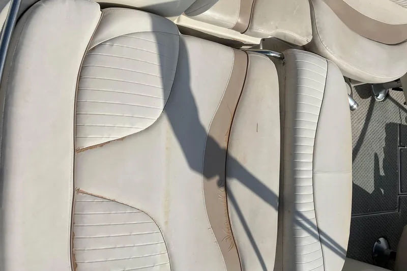 Slide: The Image of Beige leather seats of a 2007 Azure AZ240 boat, showing wear and shadow. - 25