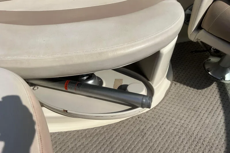 Slide: The Image of Boat interior with beige seating and carpet, featuring a storage compartment. Azure AZ240, 2007 model. - 31