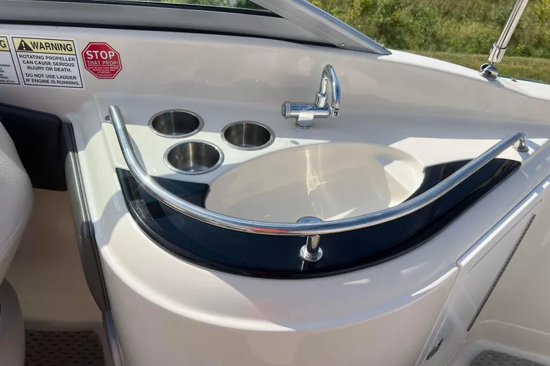 Slide: The Image of Boat sink area with faucet and cup holders on a 2007 Azure AZ240. - 34
