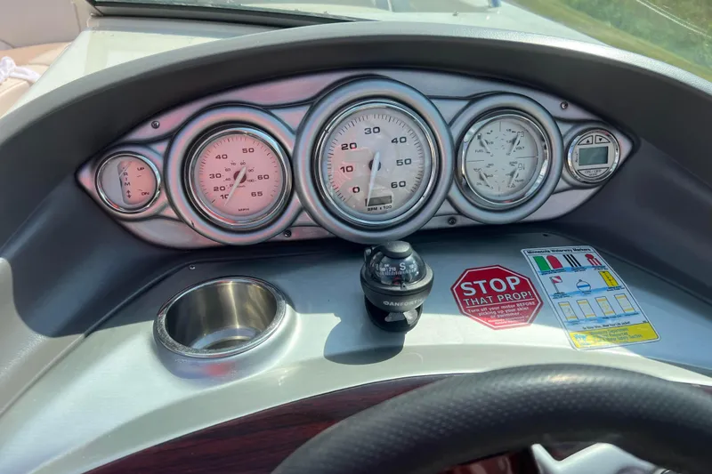 Slide: The Image of Dashboard of a 2007 Azure AZ240 boat with gauges and compass. - 39