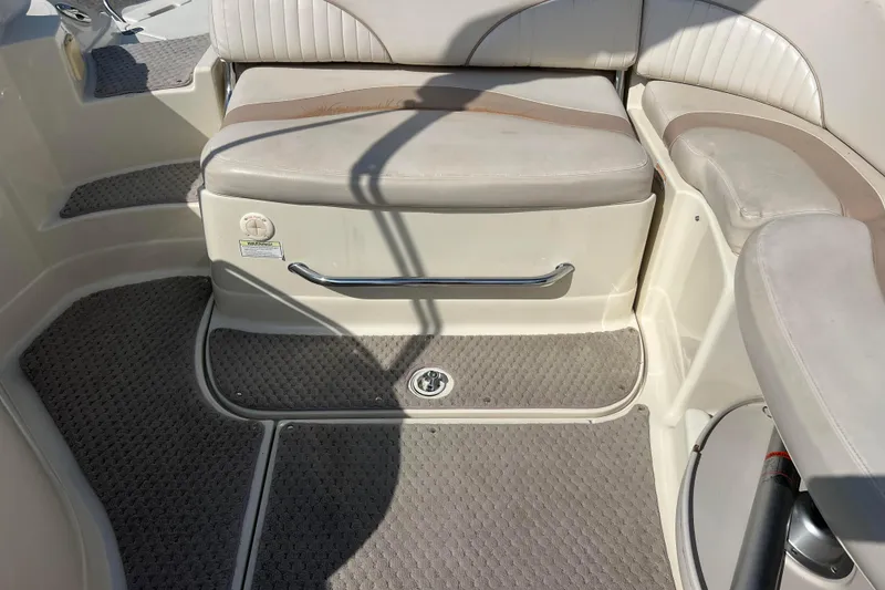 Slide: The Image of Interior seating of a 2007 Azure AZ240 boat with beige upholstery and carpeted flooring. - 43