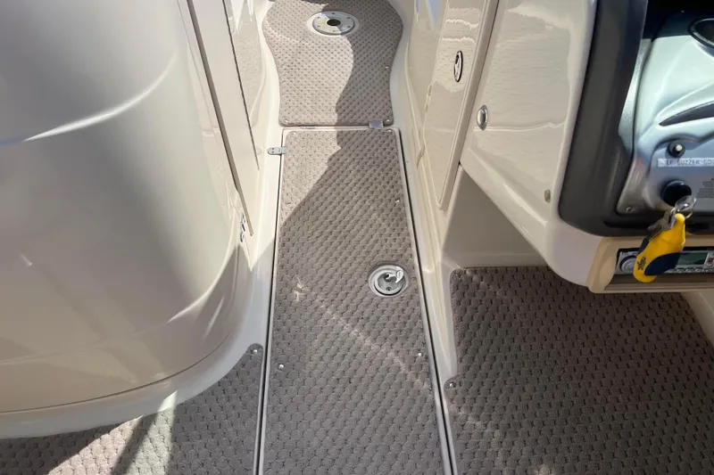 Slide: The Image of Interior view of a 2007 Azure AZ240 boat, featuring carpeted flooring and control panel. - 44