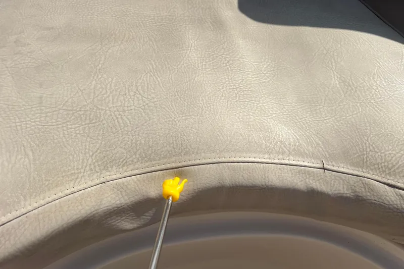 Slide: The Image of Yellow hand pointer on beige leather seat of 2007 Azure AZ240. - 54
