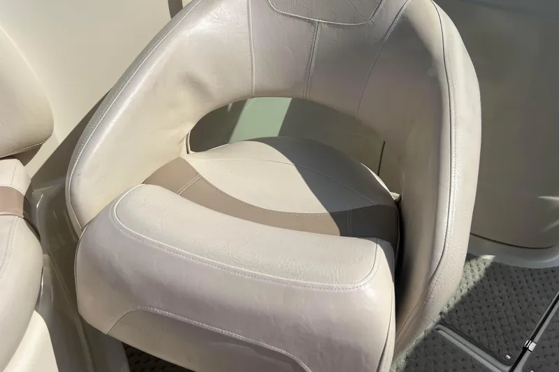 Slide: The Image of Beige leather seat in a 2007 Azure AZ240 boat, sunlight highlighting texture. - 57